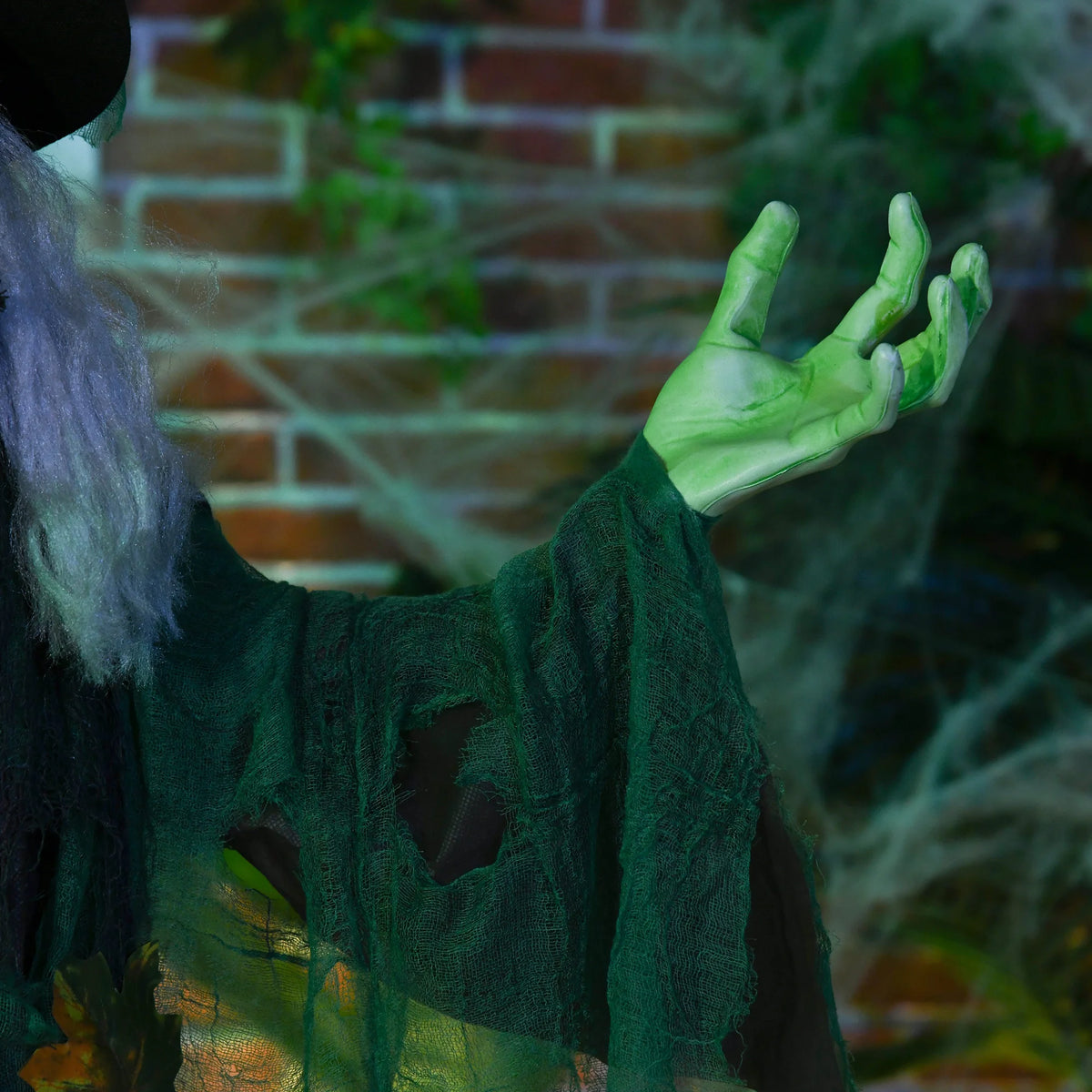 6ft Halloween witch shown in a front garden at night